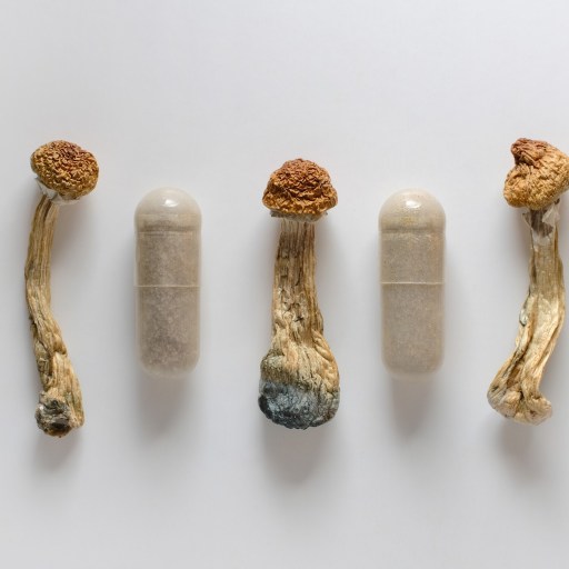 A group of marijuana pills on a white surface.