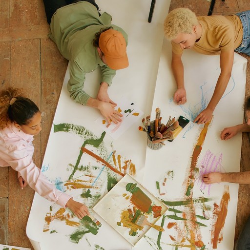 A group of people collaboratively envisioning the future of work on a piece of paper.