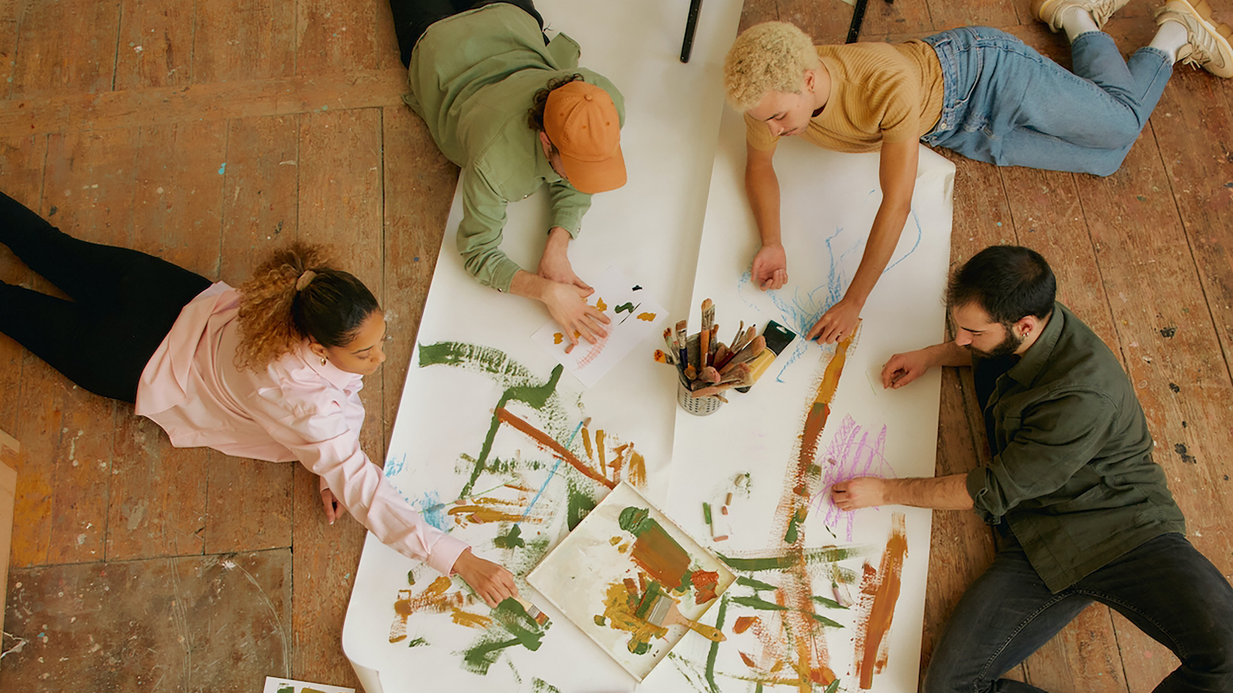 A group of people collaboratively envisioning the future of work on a piece of paper.