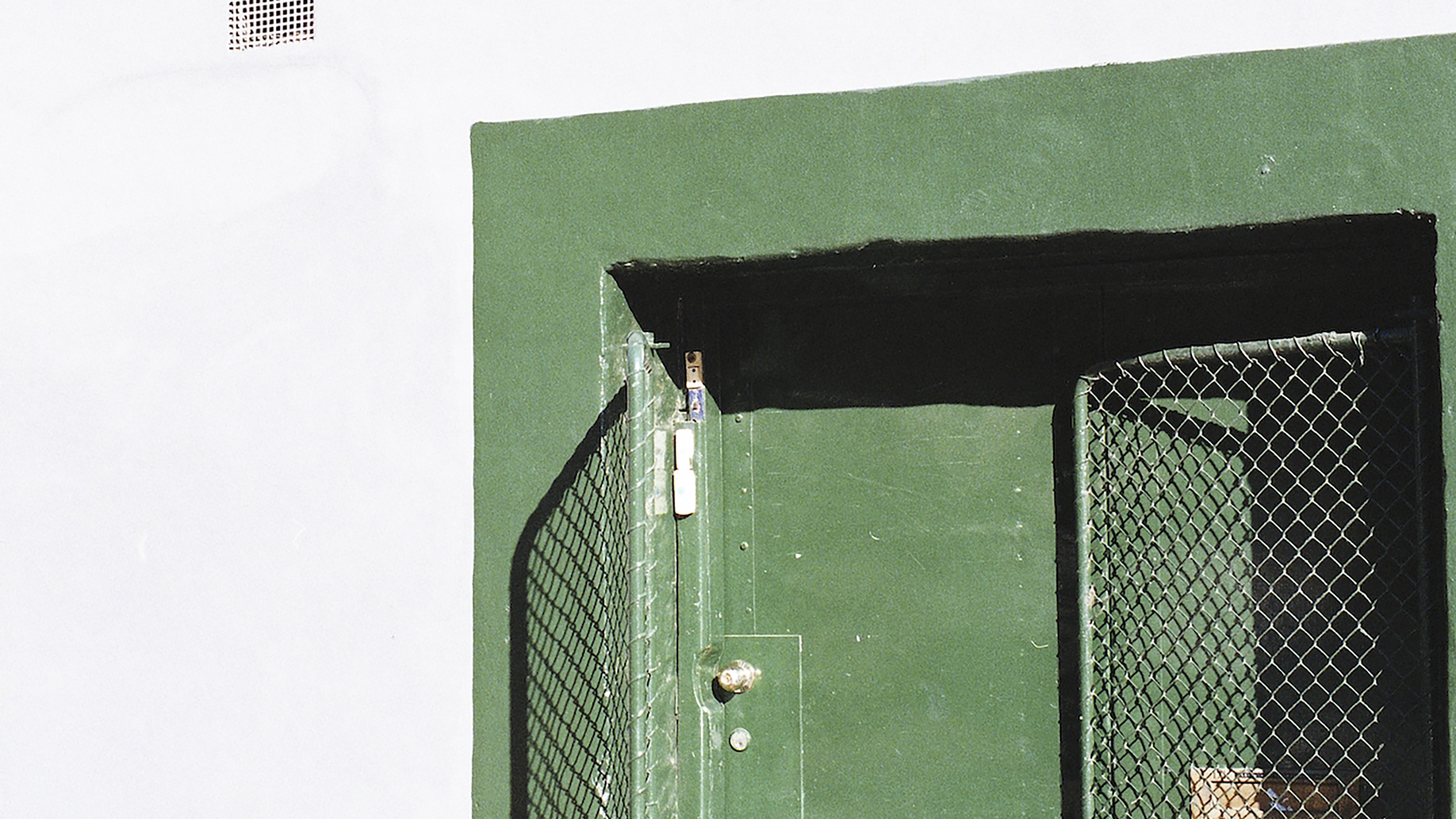 A man sitting on a bench in front of a startup exit door.