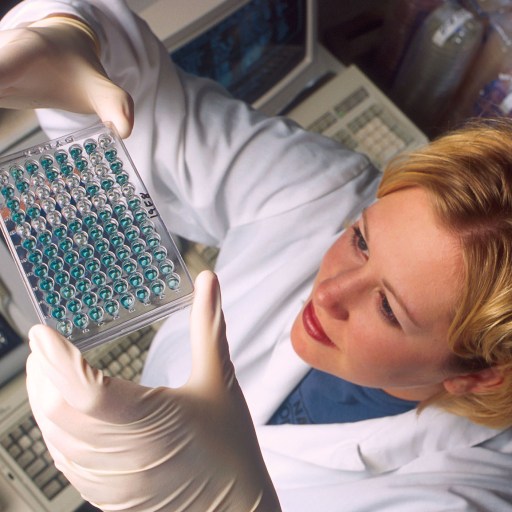 A woman wearing a lab coat researching non-hormonal birth control options.