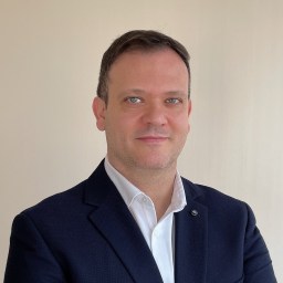 A man in a suit is posing for a photo.