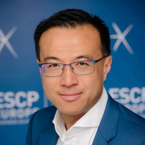 A man in glasses is posing for a photo.