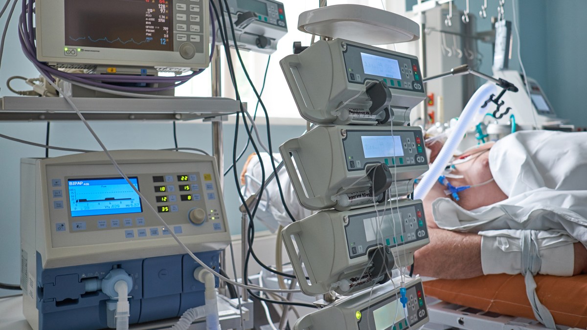 A man is having a near-death experience while laying in a hospital bed.