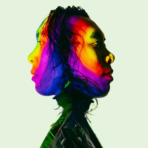 A man's head with a psychedelic rainbow colored face.