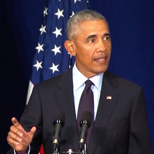 President Barack Obama delivers a persuasive speech from a podium.