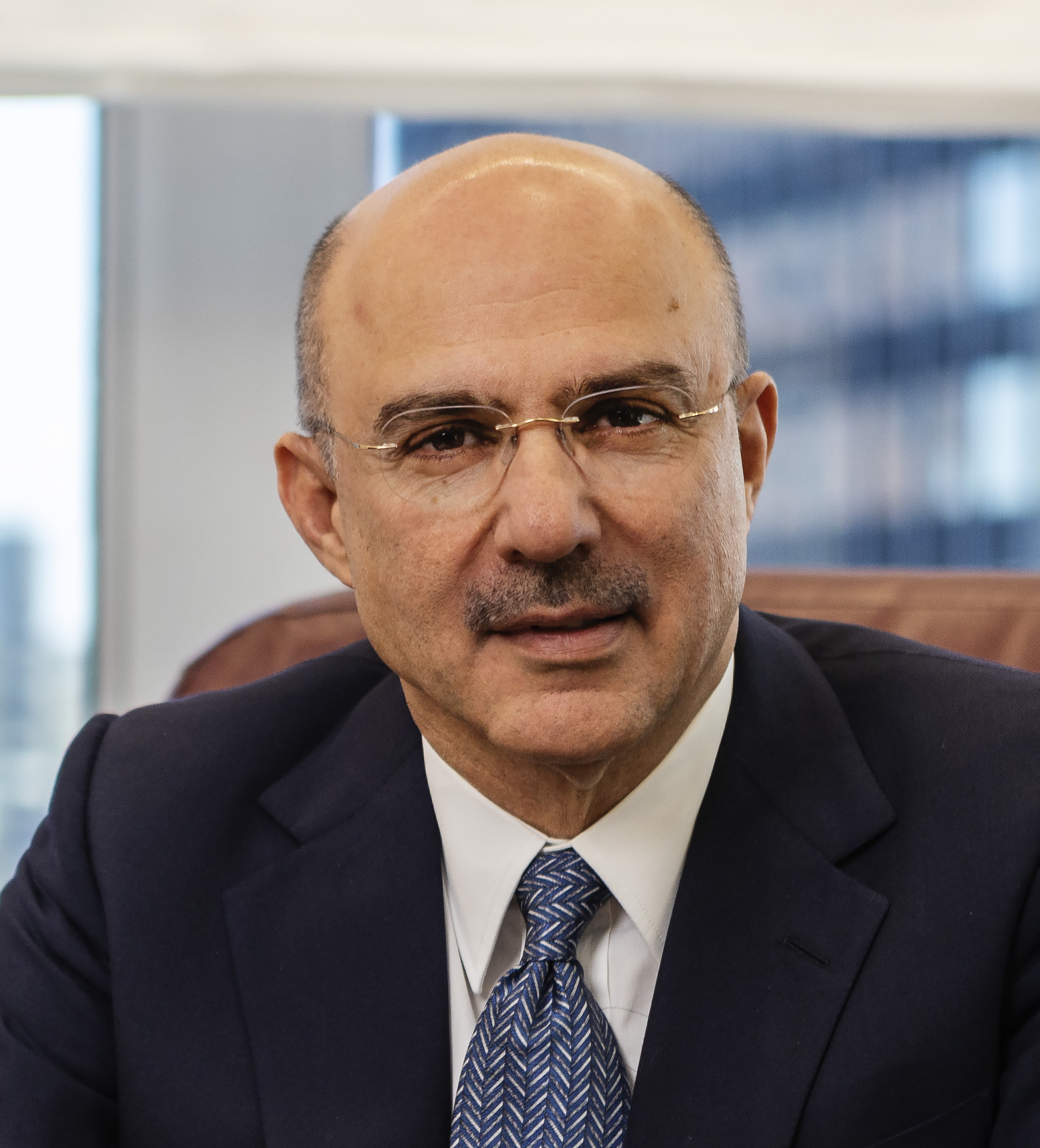 A bald man in a suit and tie.