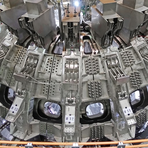 A record-breaking nuclear fusion experiment showcases a large machine in a factory.