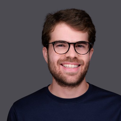 A man with glasses is smiling for the camera, showcasing his ability to operate at all levels.