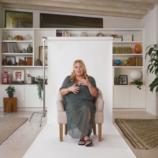 A woman sitting on a chair in a living room.