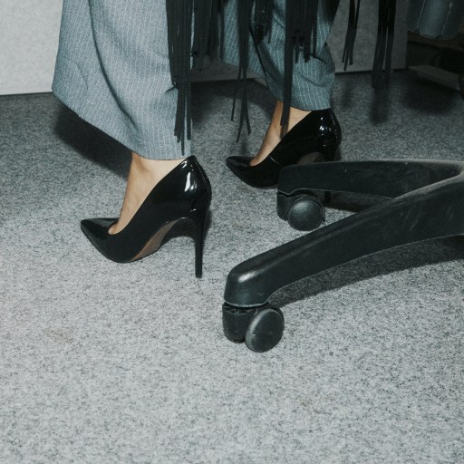 An integrated woman's feet resting on a chair.
