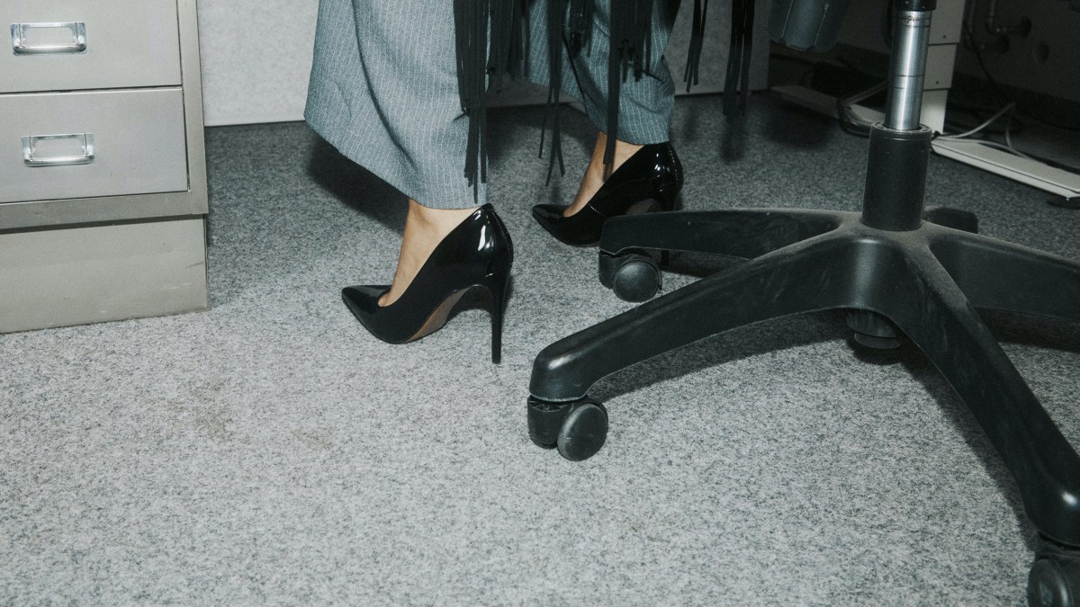 An integrated woman's feet resting on a chair.