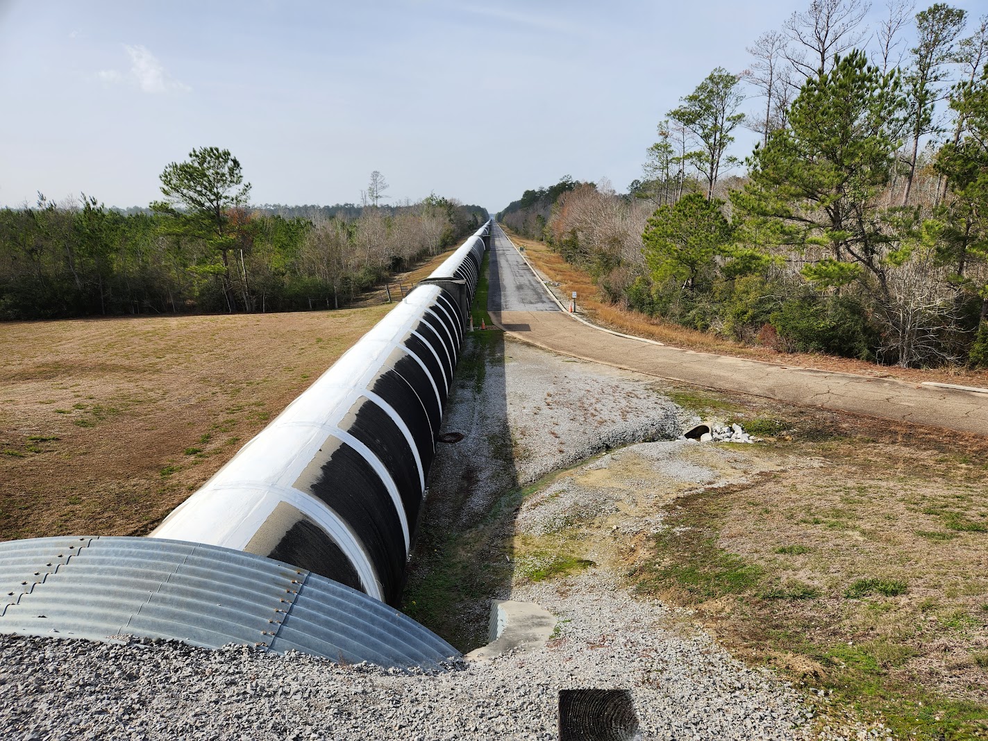A long black hole with trees.