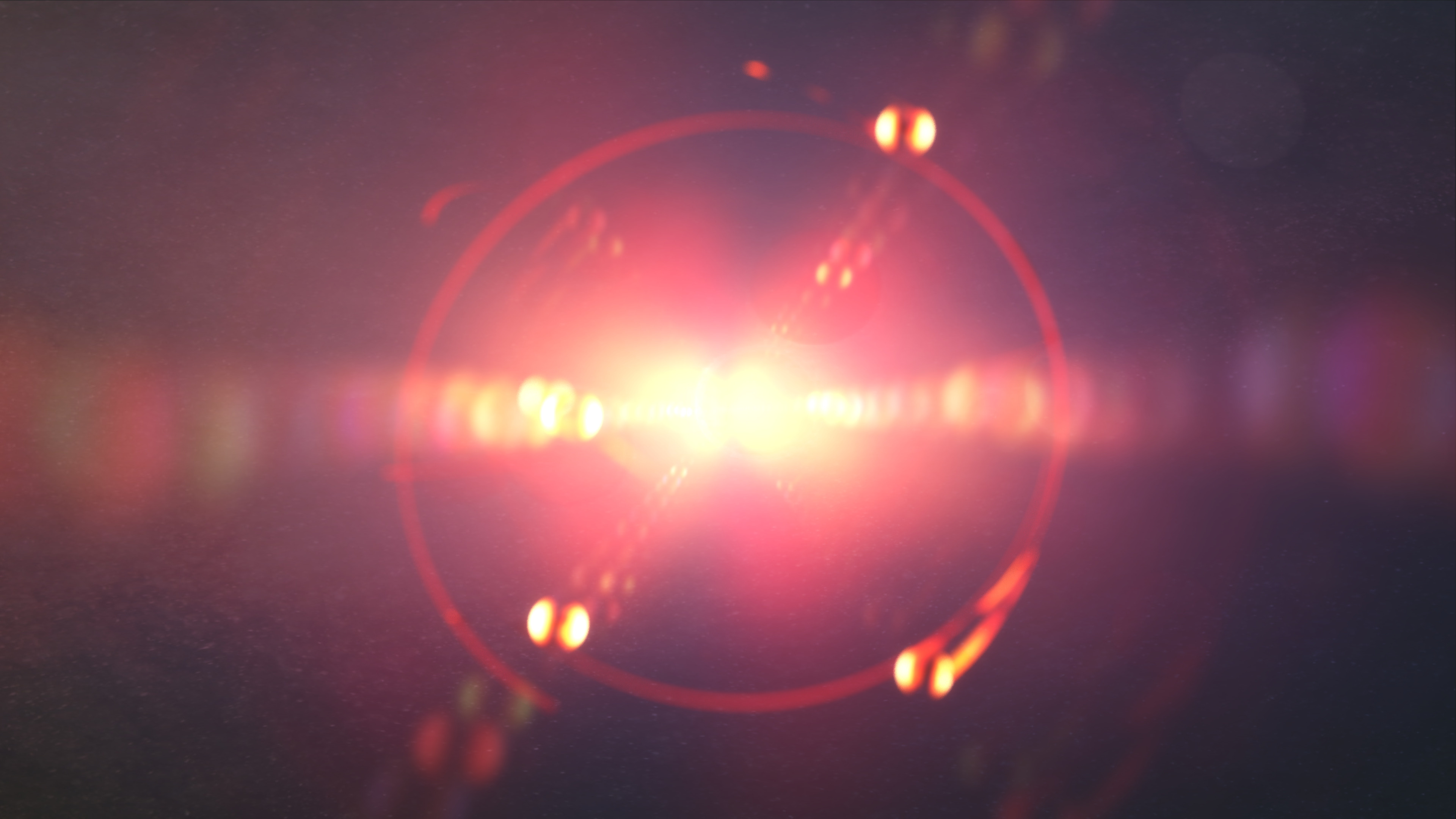 An image of a red light shining on a dark background.