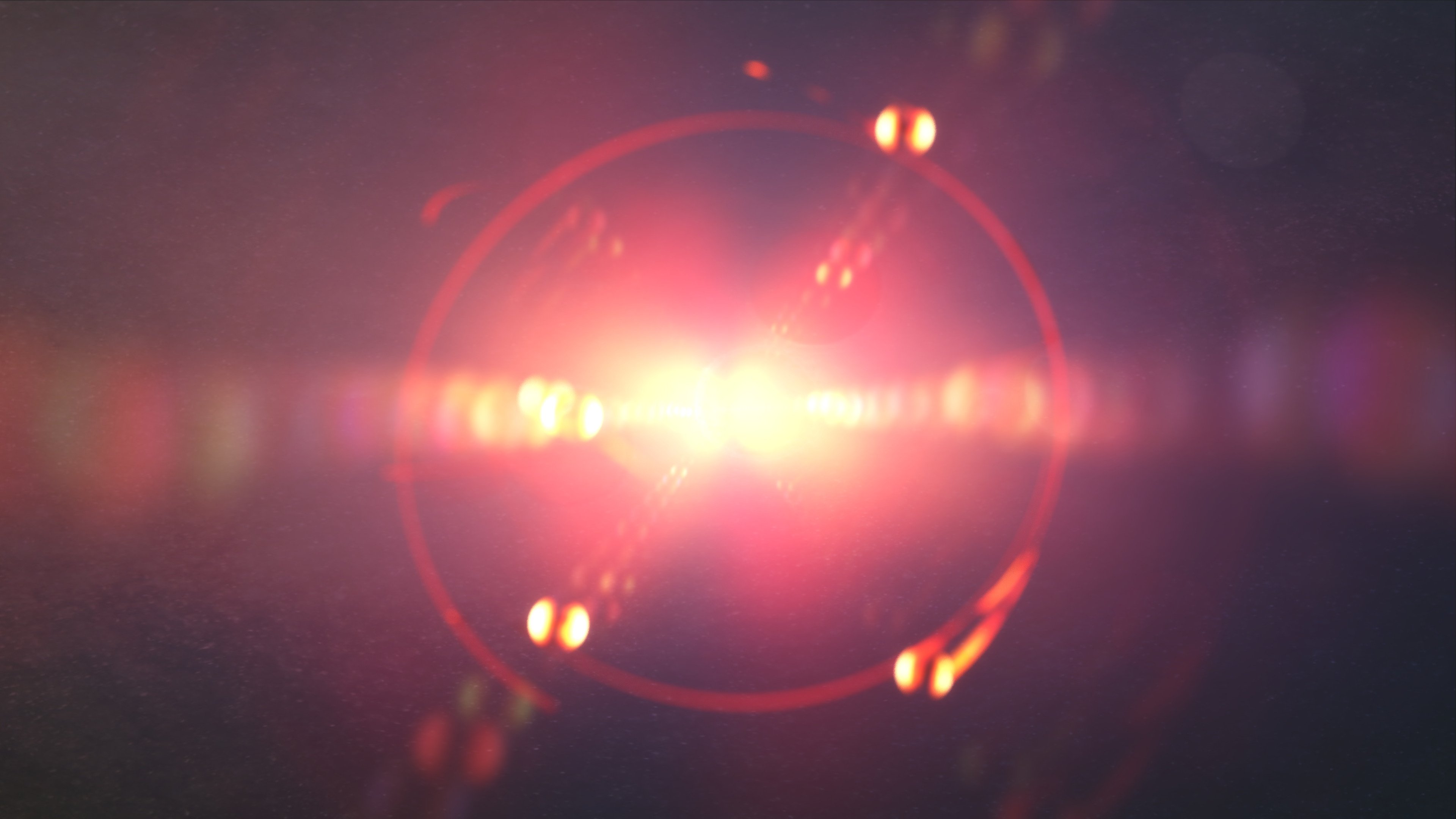 An image of a red light shining on a dark background.
