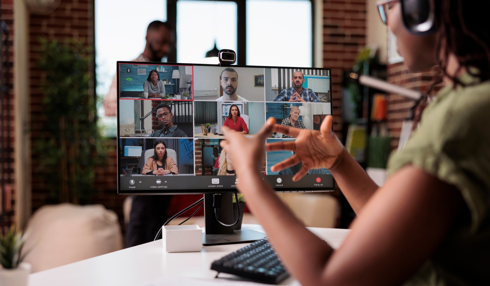 A woman is using a computer to make a video call.