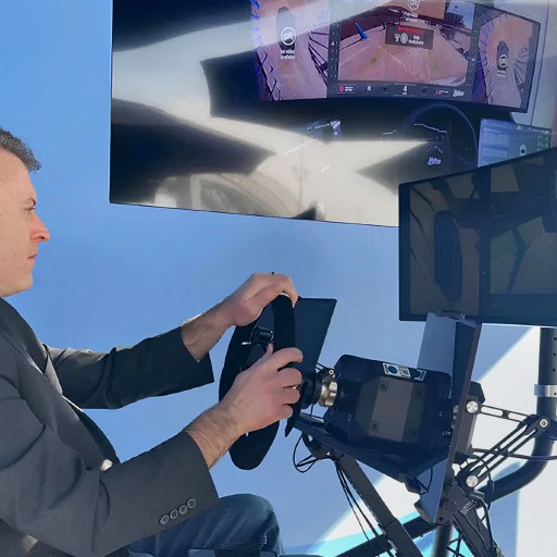 A man sitting in a chair in front of a tv.