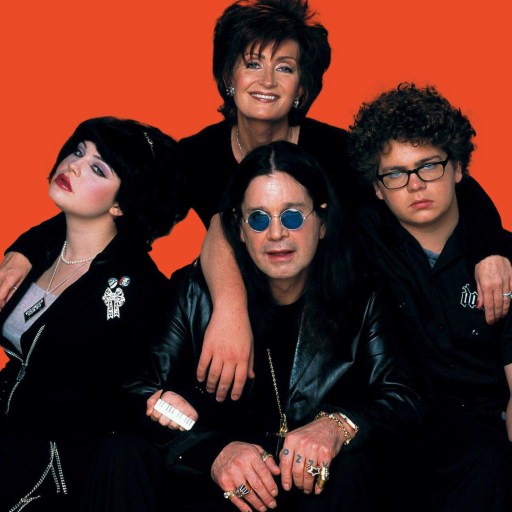 A group of people posing in front of an orange background.