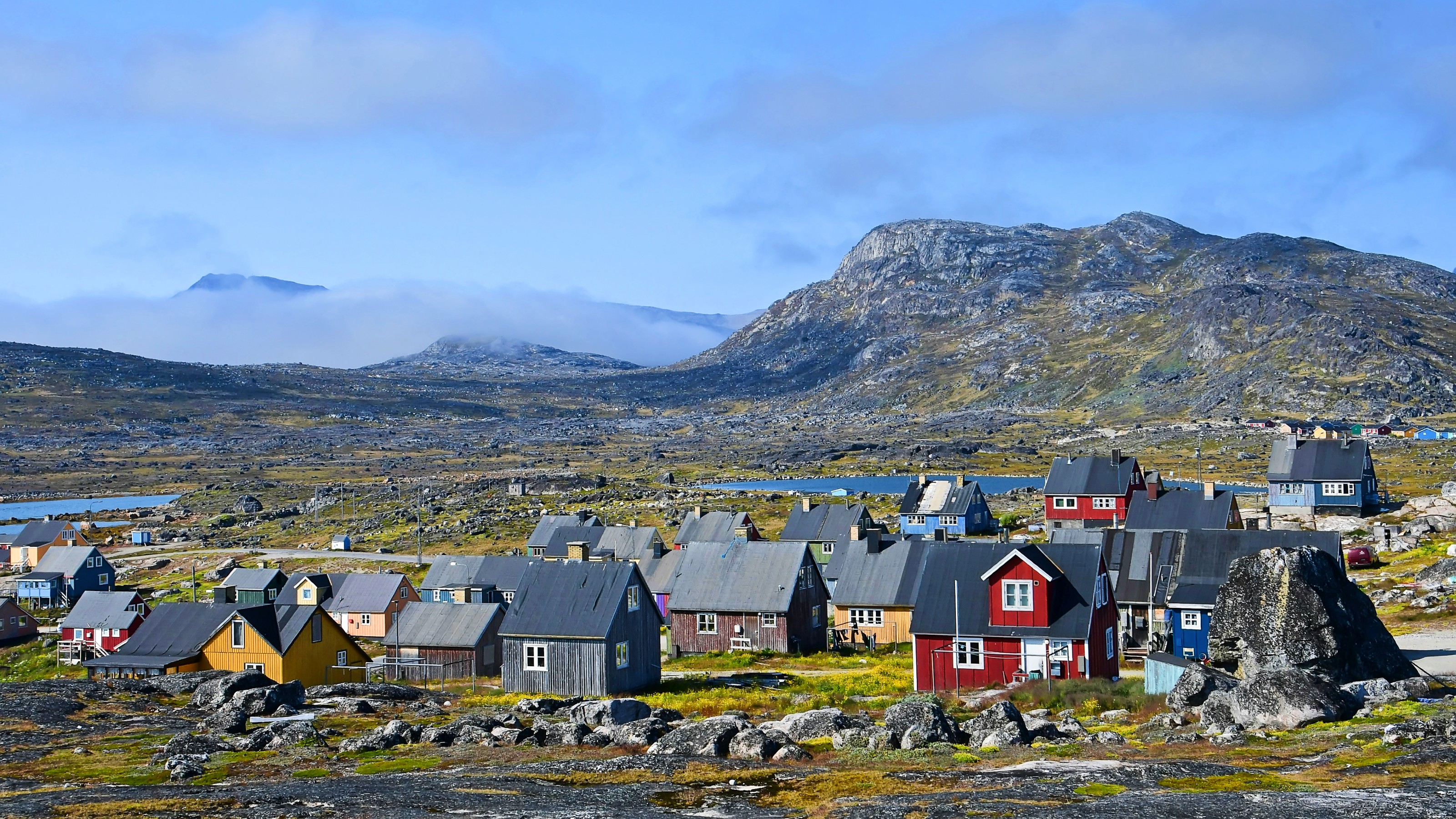 A cluster of vibrant houses perched on a mountainside, offering a sense of life satisfaction.