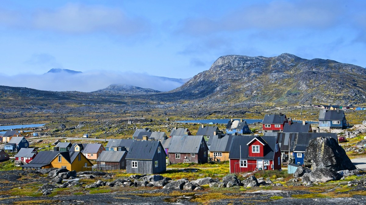 A cluster of vibrant houses perched on a mountainside, offering a sense of life satisfaction.