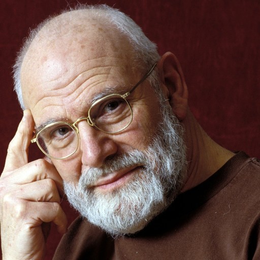 An older man with glasses and a beard posing for a picture.