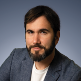 A man with a beard and a white shirt.