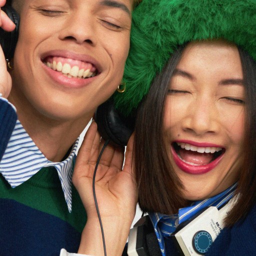 A woman feeling the music in a green hat.