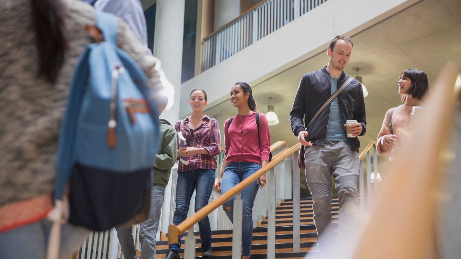 A group of people walking down stairs in a building.