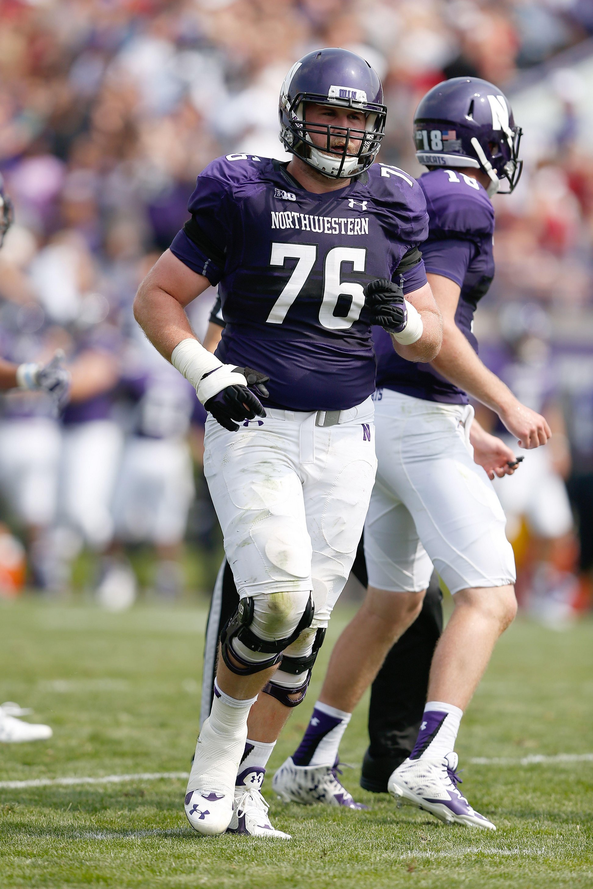 A football player is running on the field.