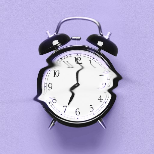 A broken alarm clock on a purple background, reminiscent of a Tali Sharot study.