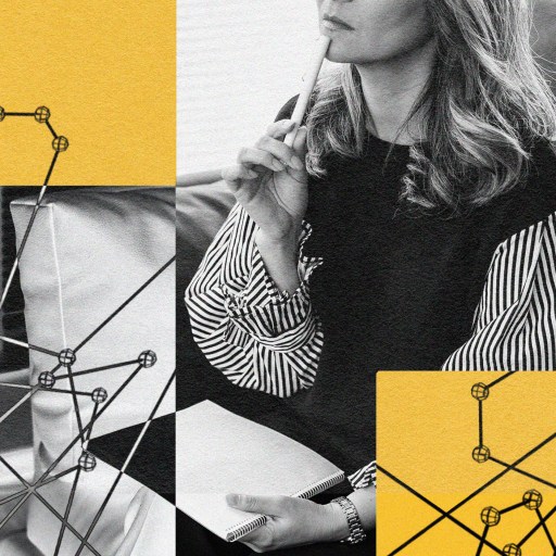 A black and white photo of a beautiful woman sitting on a couch.