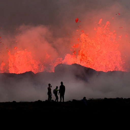 Spectators observing a dramatic eruption from active volcanoes at twilight.
