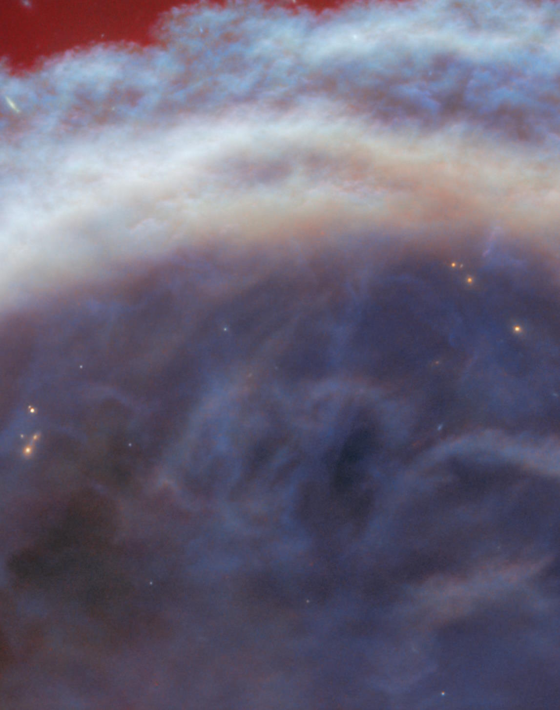 Colorful space nebula with swirling clouds of blue and white, highlighted by red accents at the top, resembling the iconic Horsehead Nebula as captured by JWST.