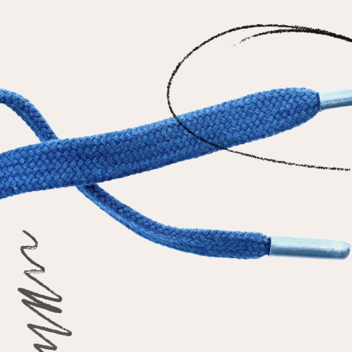 Close-up of a blue shoelace with silver aglets, transforming ordinary things into art against a plain background featuring black squiggle and circular sketch marks.
