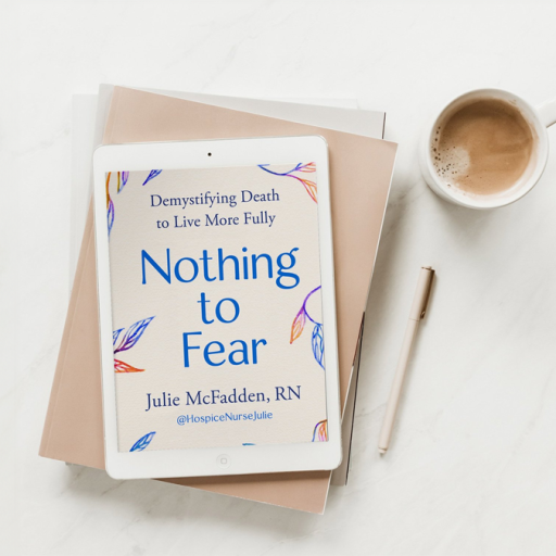 A tablet displaying the cover of the book "Nothing to Fear" by Julie McFadden, RN, lies on top of stacked books next to a pen and a cup of coffee on a white surface.