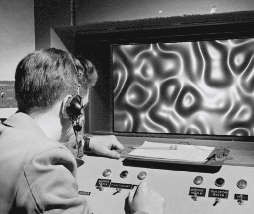 A man sits at a control panel with knobs and buttons, wearing a headset, looking at a screen displaying abstract, distorted wavy patterns—the antidote for leaders in navigating complex data.