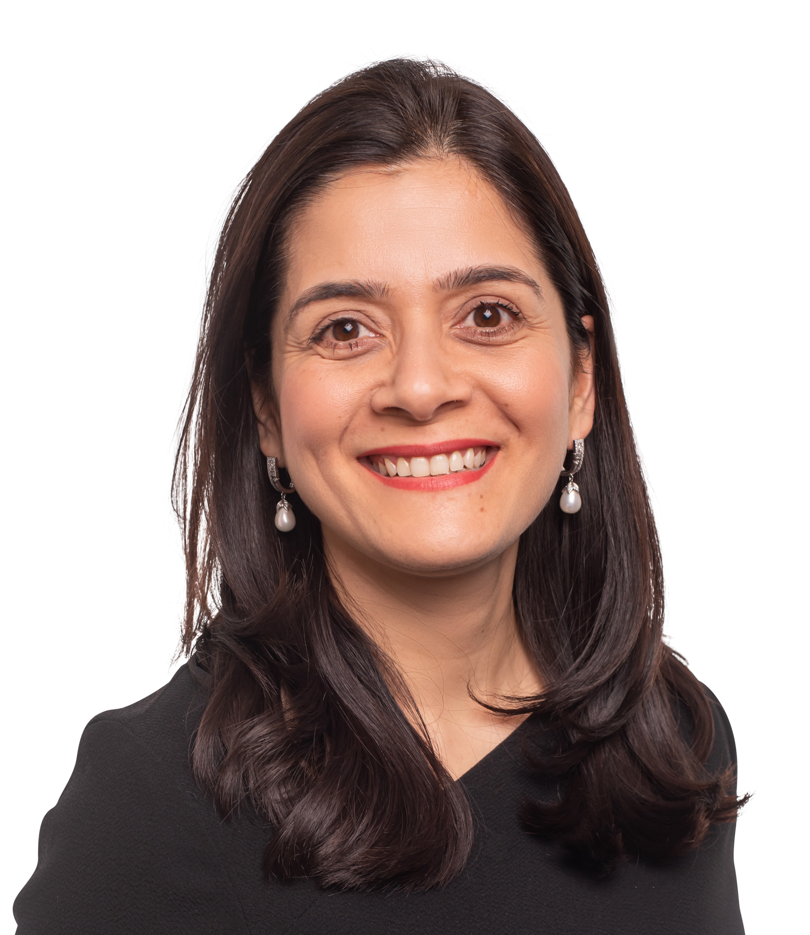 A woman with long dark hair, wearing pearl earrings and a black top, smiles at the camera against a white background.