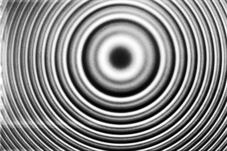 Monochrome concentric circles radiate from a central point, creating a ripple-like pattern reminiscent of nature&rsquo;s own design.
