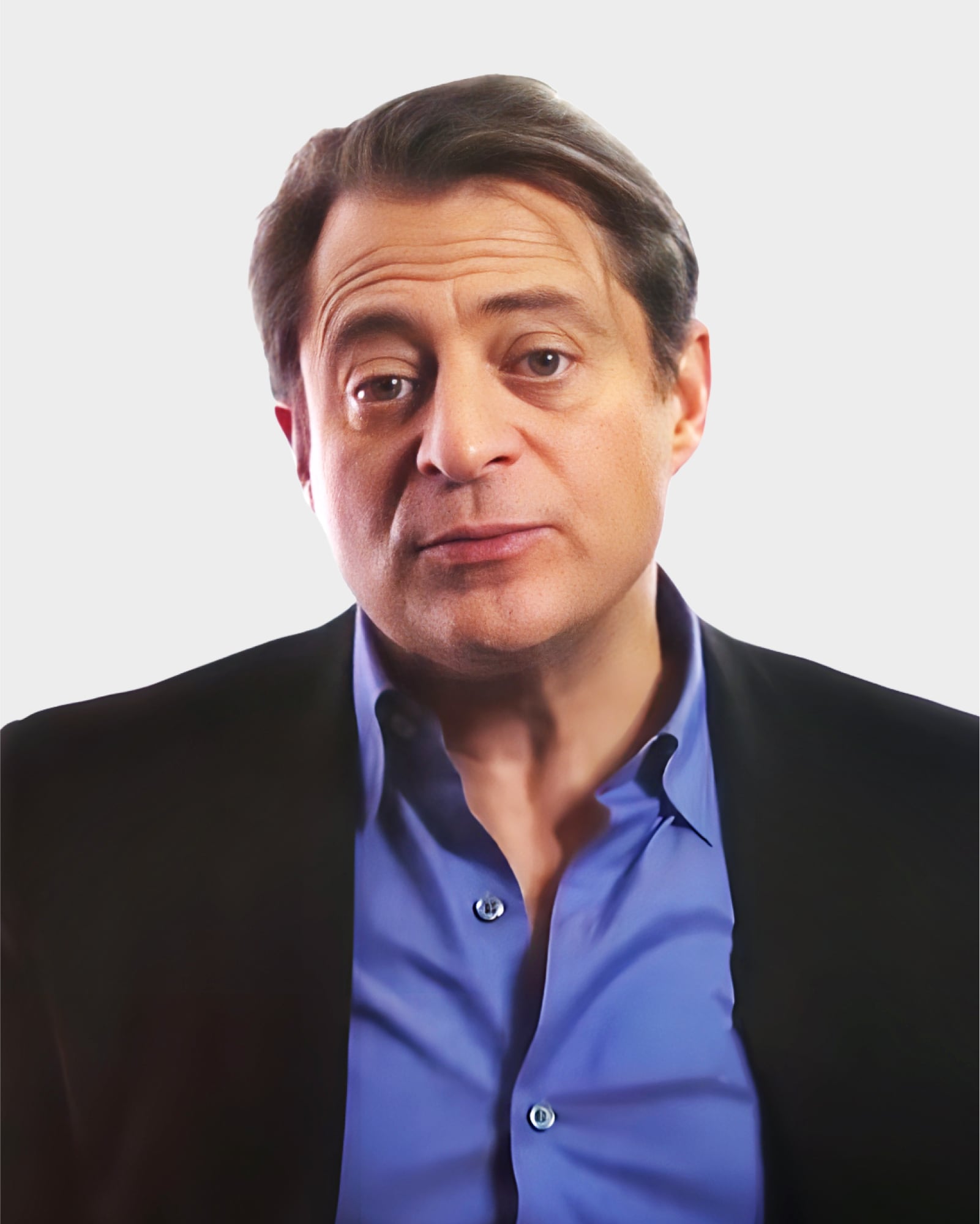 A person with short dark hair wearing a blue shirt and black jacket, looking towards the camera against a plain background.