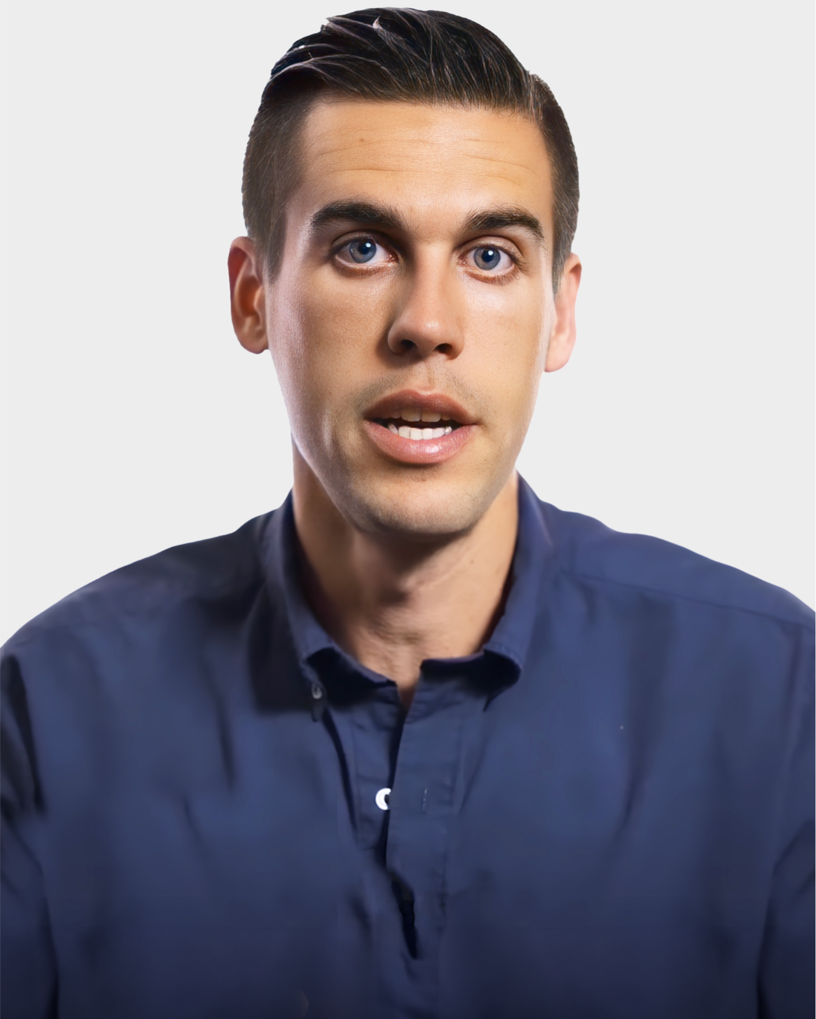 Person with short dark hair wearing a blue shirt against a plain background.