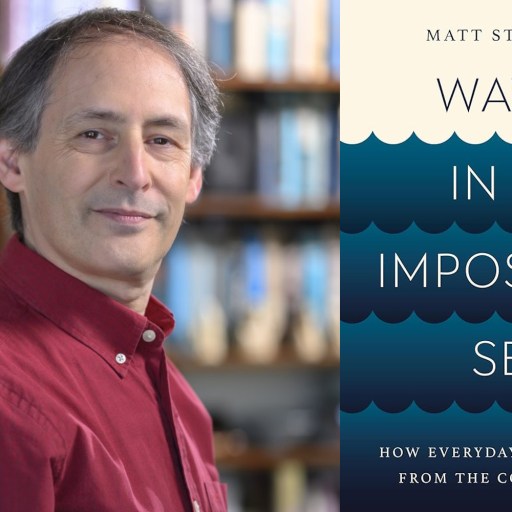A person in a red shirt stands next to "Waves in an Impossible Sea," the 2024 science book by Matt Strassler. The background displays a blurred bookshelf.