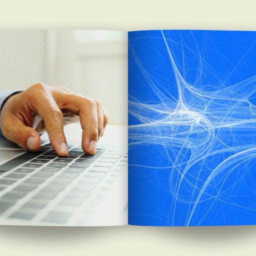 An open magazine displays a snapshot of AI efficiency: on the left page, a person types diligently on a laptop, while the right page showcases an abstract blue and white digital design, symbolizing the seamless integration of technology and human creativity.