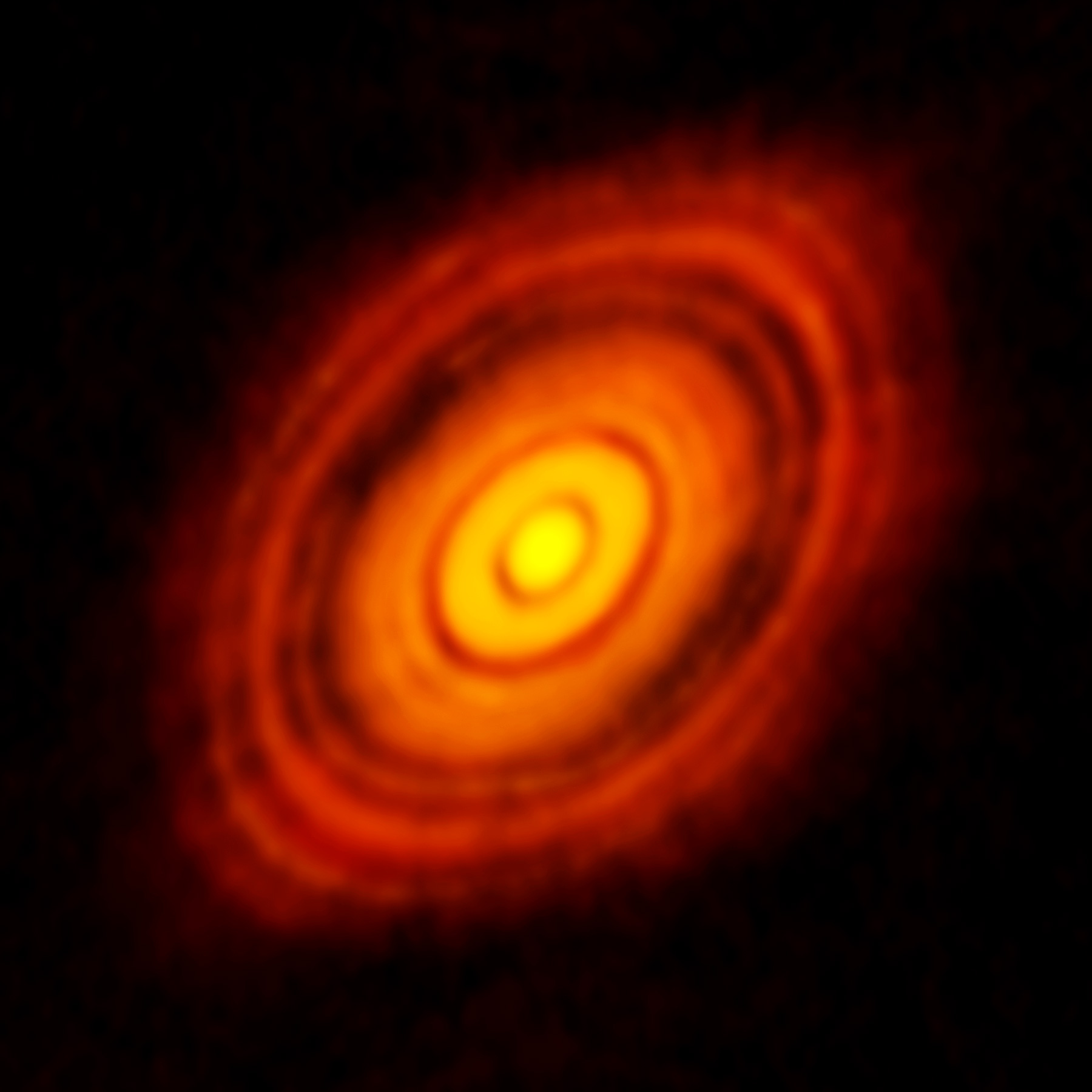Bright, concentric rings surrounding a glowing central core, resembling a protoplanetary disk on a dark background&mdash;a snapshot capturing the JWST's glimpse into star system birth.