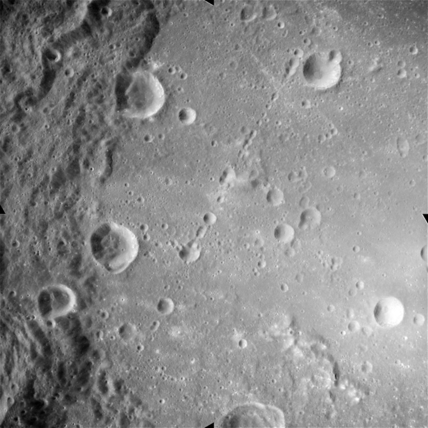 A black and white image captures the lunar surface, revealing various craters and rugged terrain reminiscent of a celestial Grand Canyon.