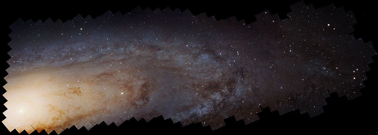 Experience the largest galactic mosaic, showcasing a panoramic view of a galaxy with dense star fields and swirling dust lanes, all set against a dark space background.