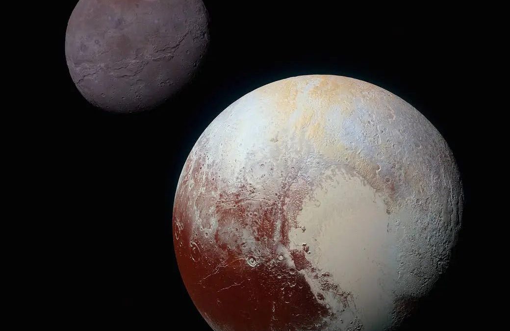 Image of Pluto and its moon Charon in space. Pluto shows distinct surface features with areas of varying colors, while Charon appears smaller with a darker, smoother surface.