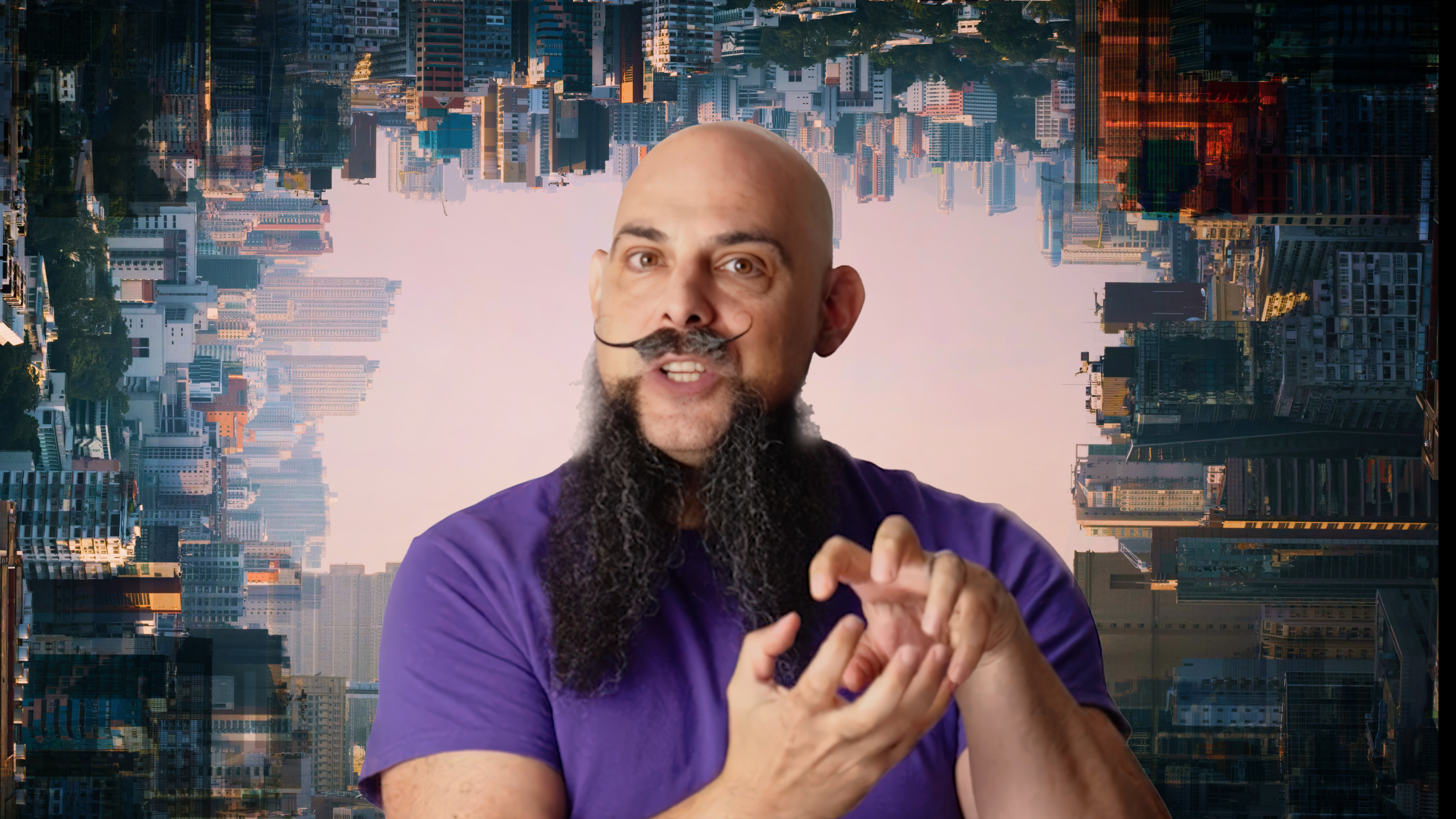 A bald man with a long beard and handlebar mustache gestures with his hands against a backdrop of an upside-down cityscape wearing a purple shirt.