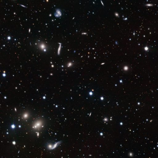 A vast starry sky showcases a spinning galaxy, a relic from 12 billion years ago, among countless stars of varying brightness on a dark background.