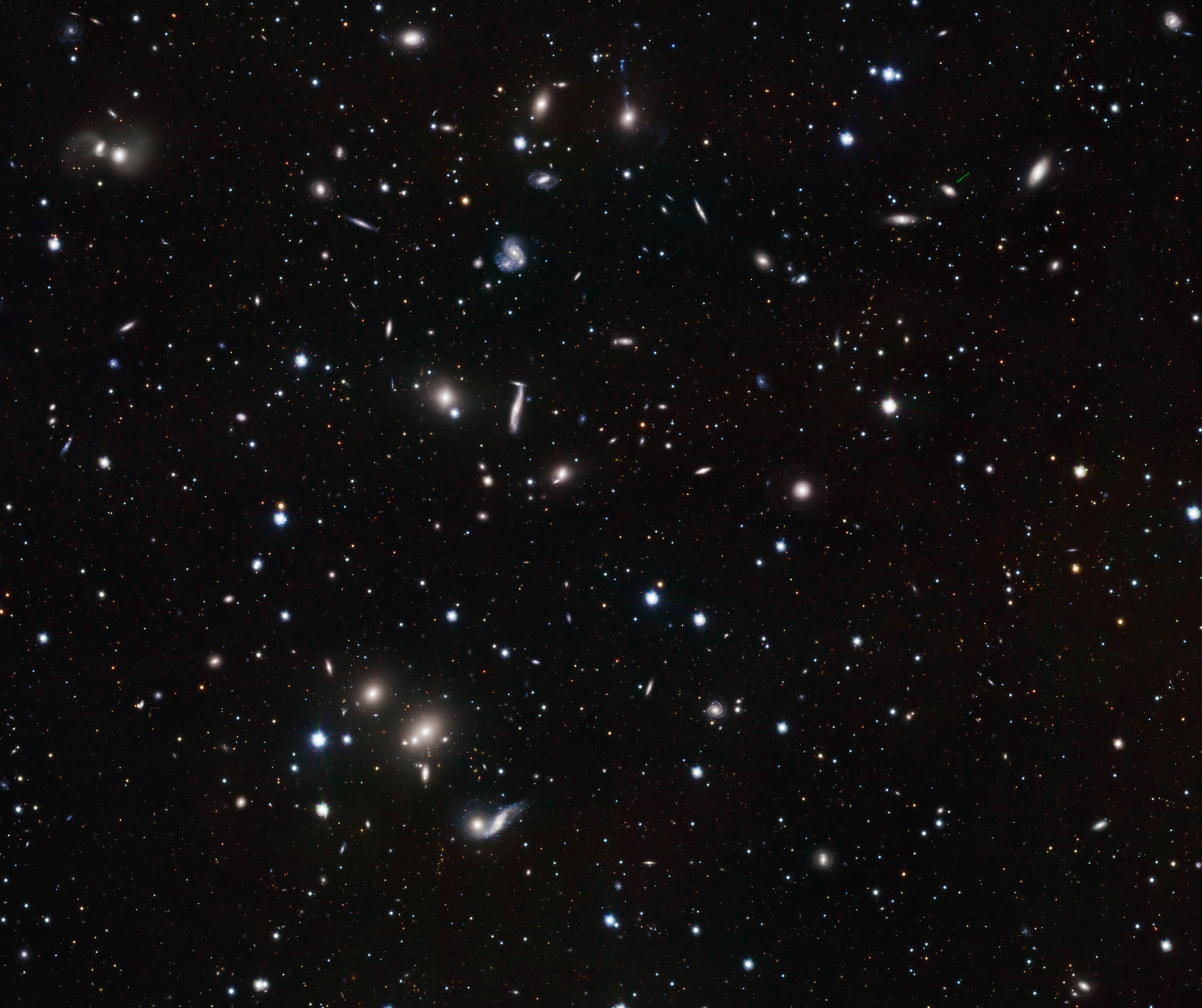 A vast starry sky showcases a spinning galaxy, a relic from 12 billion years ago, among countless stars of varying brightness on a dark background.