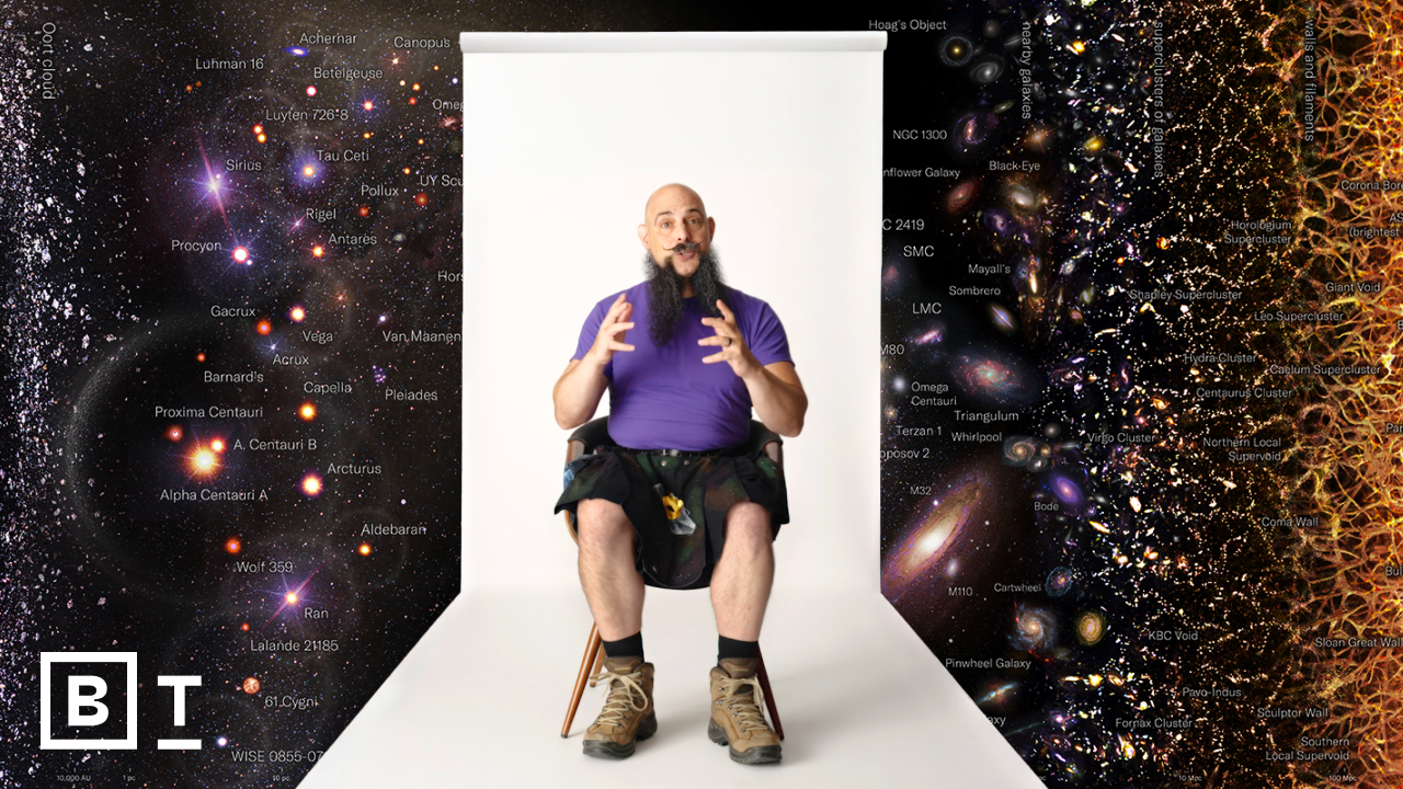A person sits in front of a white backdrop, surrounded by a cosmic map with galaxies and celestial objects.